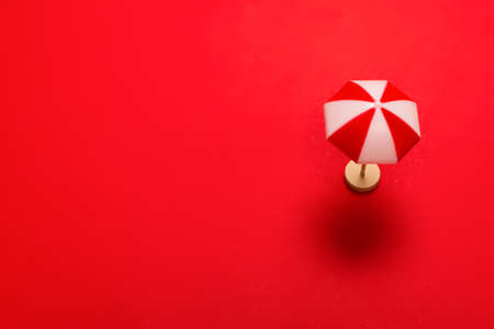Red umbrella on a red background. Copy space.の写真素材