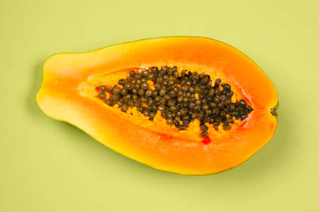 Papaya fruit on a green background. Tropical fruit. Half papaya.の写真素材