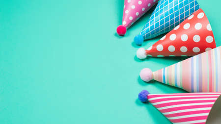 Colorful birthday caps on a blue background. Top view. Copy space.の写真素材