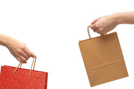 Paper bag in woman hands isolated on white background.の写真素材