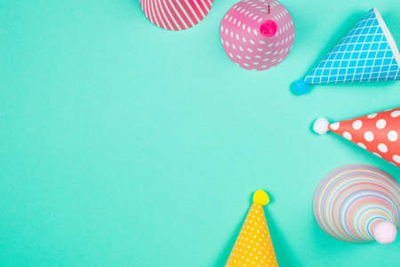 Colorful birthday caps on a blue background. Top view. Copy space.の写真素材