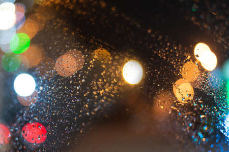 Blurred background with raindrops and lights.の写真素材