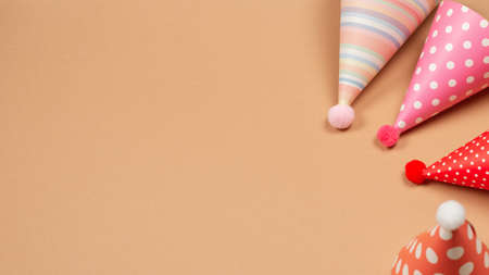 Colorful birthday cap on brown background. Copy space.の写真素材