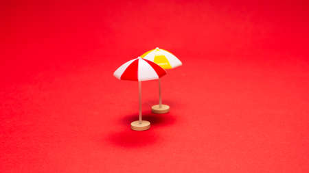 Yellow umbrella on a red background. Copy space.