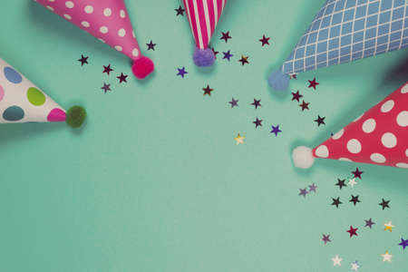 Colorful birthday caps on a blue background. Top view. Copy space.の写真素材