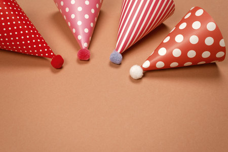 Colorful birthday cap on brown background. Copy space.の写真素材