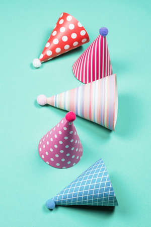 Colorful birthday caps on a blue background. Top view. Copy space.の写真素材