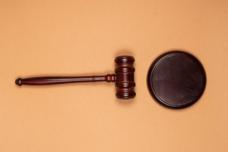 Gavel down on stand on brown background. Justice of law system conceptual. Copy space.の写真素材