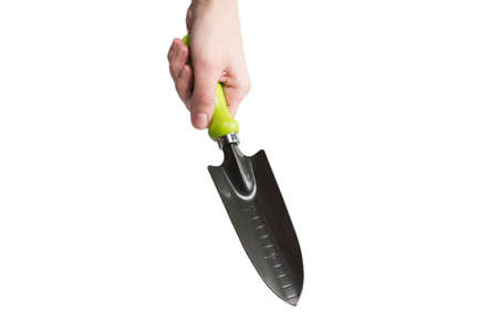 Little green shovel in woman hand isolated on white background.の写真素材