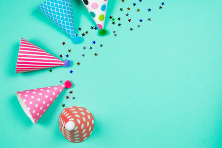 Colorful birthday caps on a blue background. Top view. Copy space.の写真素材