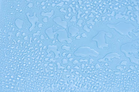 Blue glass with water drops. Wet glass. Copy space.