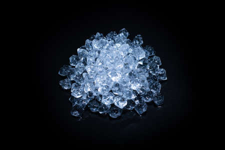 Ice crystal cubes on a black background, space for text or design.の写真素材