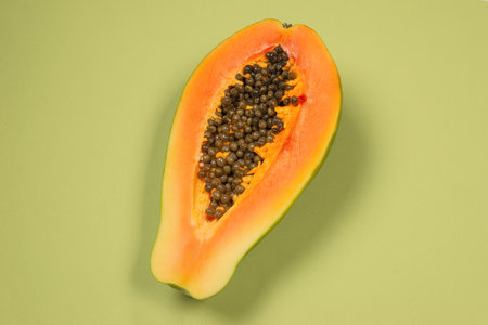 Papaya fruit on a green background. Tropical fruit. Half papaya.の写真素材