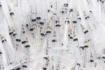 Many medical syringes as a background. Medical equipment.の写真素材