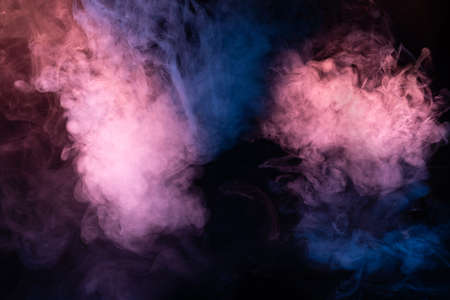 Blue and pink steam on a black background. Copy space.の写真素材