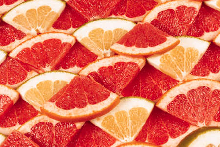 Pomelo and grapefruit juicy slices background.の写真素材
