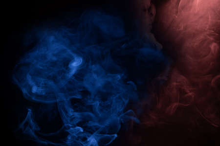 Blue and pink steam on a black background. Copy space.の写真素材
