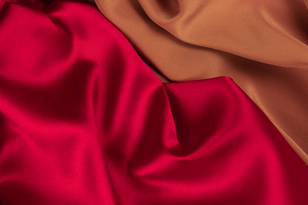 Red and orange silk or satin luxury fabric texture can use as abstract background. Top view.の写真素材