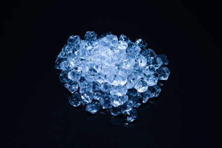 Ice crystal cubes on a black background, space for text or design.の写真素材