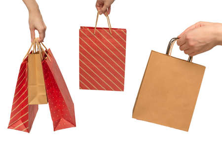 Paper bag in woman hands isolated on white background.の写真素材