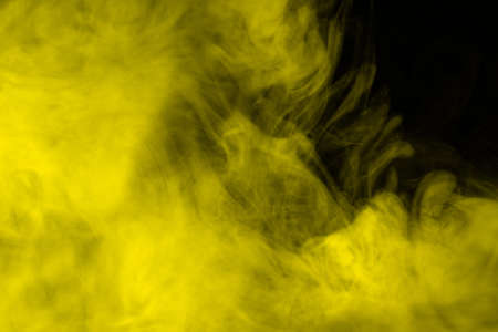Yellow steam on a black background. Copy space.の写真素材