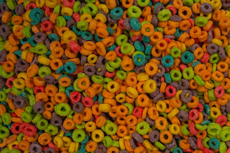 Sweet multicolored flakes, cereal loops as a background ..