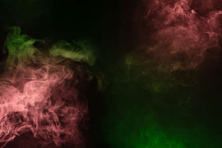Green and pink steam on a black background. Copy space.の写真素材