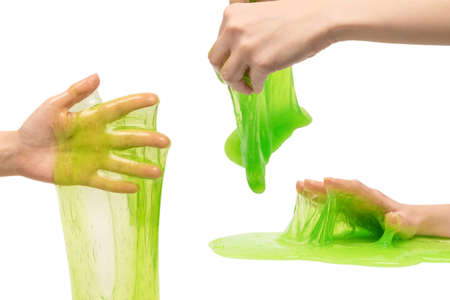 Green slime toy in woman hand isolated on white background.の写真素材