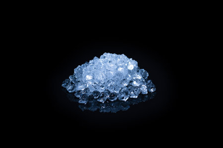 Ice crystal cubes on a black background, space for text or design.の写真素材