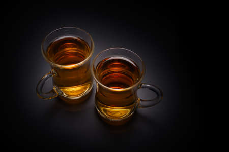 Turkish glass of tea on a black background.の写真素材