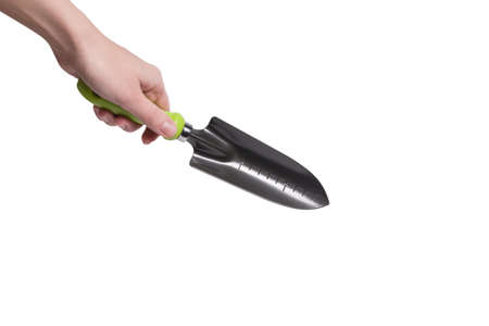 Little green shovel in woman hand isolated on white background.の写真素材