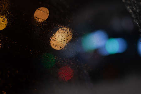 Blurred background with raindrops and lights.の写真素材