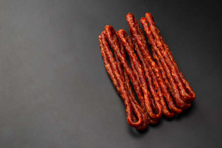 Cabanossi, dry sausage isolated on a black background.の写真素材