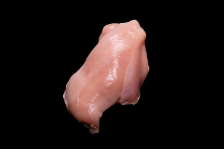 Raw chicken fillet isolated on a black background. top view.の写真素材