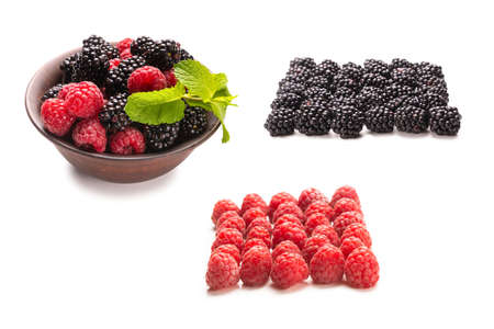 Raspberry, blackberry and mint leaf in ceramic brown bowl isolated on white background.