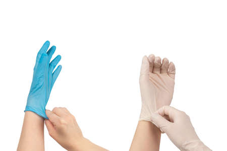 Woman puts on blue rubber gloves. Isolated on white.