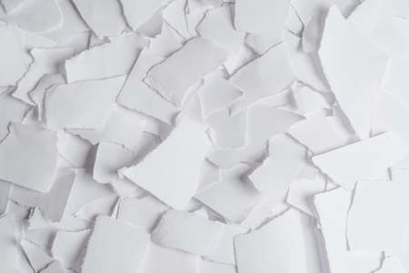 Empty white paper pieces as a background. Space for text or design.の写真素材