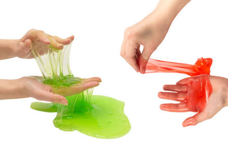 Green slime toy in woman hand isolated on white background.