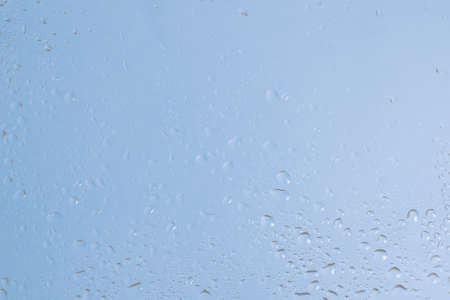 Blue backgrond with water drops. Wet glass. Copy space.