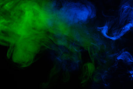 Blue and pink steam on a black background. Copy space.の写真素材