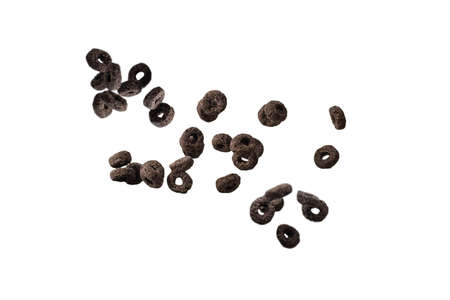 Chocolate rings cereal spill out into a bowl. Breakfast. Isolated on a white background.の写真素材