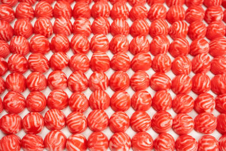 Red round tasty gummy candies as a background. top view.の写真素材