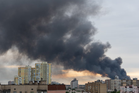 Thick smoke in the clouds, fire in a city.の写真素材