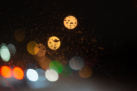 Blurred background with raindrops and lights.の写真素材