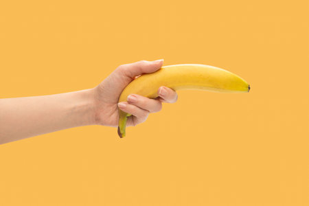 A bunch of bananas in woman hand isolated on a white background.の写真素材