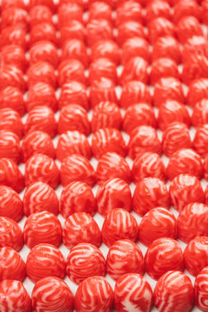 Red round tasty gummy candies as a background. top view.