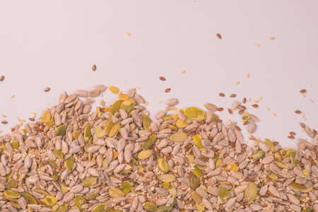 Mix of seeds for a salad. A pile of mixed seeds isolated on a white background.の写真素材