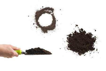 Little green shovel with soil in woman hand isolated on white background.の写真素材