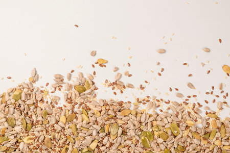 Mix of seeds for a salad. A pile of mixed seeds isolated on a white background.の写真素材
