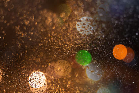 Blurred background with raindrops and lights.の写真素材